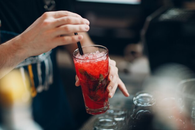 Bartender makes red ice lemonade