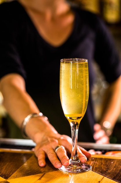 Bartender making Bellini cocktail in Italian restaurant.