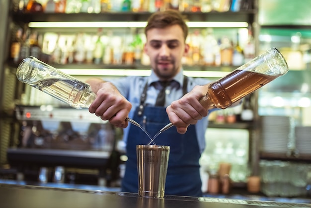 The bartender making a cocktail on the bar