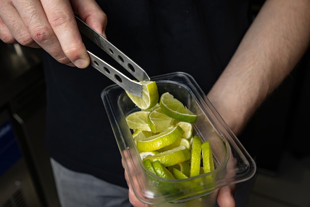 bartender making cocktail with lemon and mint