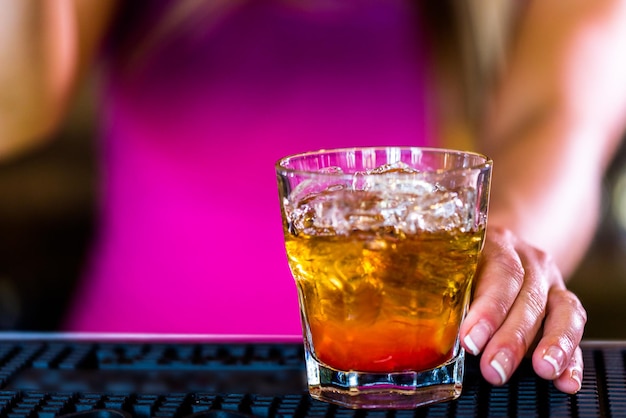 Bartender making new old fashioned cocktail in Italian restaurant.