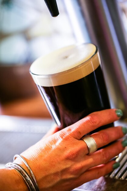 Bartender pouring draft beer in the bar.