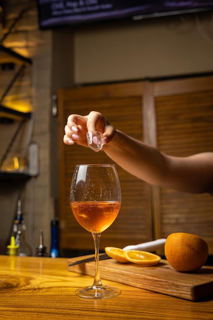 A bartender prepares a cocktail at the restaurant bar