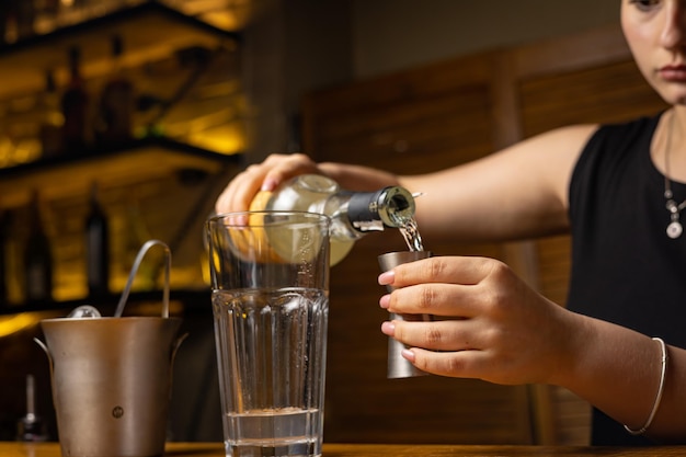 A bartender prepares a cocktail at the restaurant bar