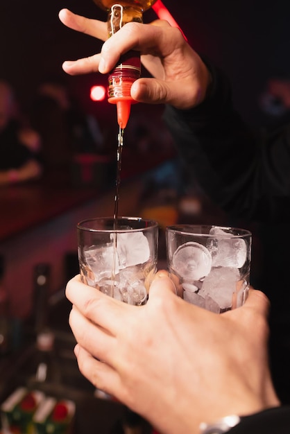 The bartender prepares cocktails in a nightclub