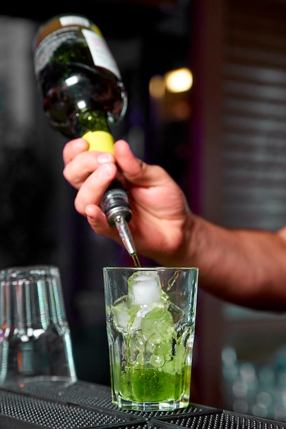 Bartender prepares cold cocktails in the nightclub.