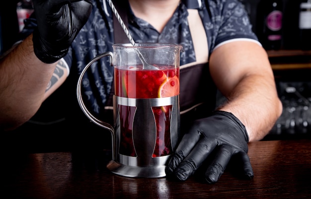 Bartender prepares hot fruit