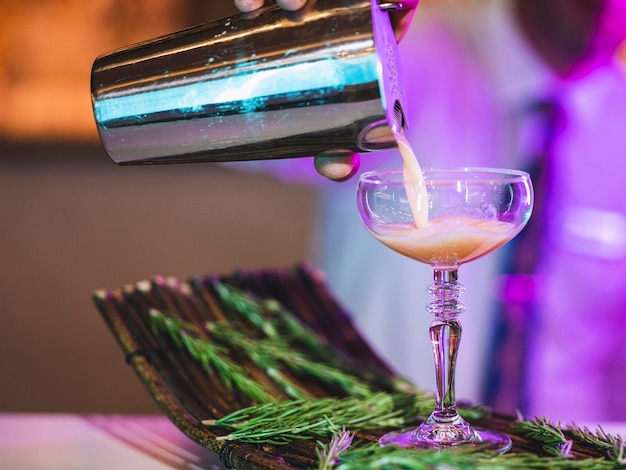 A bartender preparing a cocktail at the bar