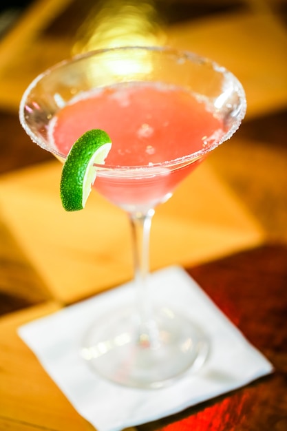 Bartender preparing Cosmopolitan drink for customer.