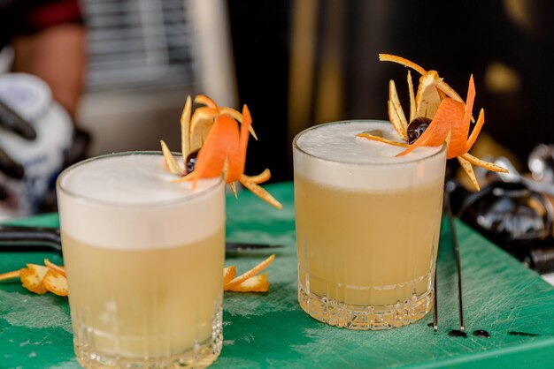 Bartender preparing and decorating cocktails at the bar profession concept