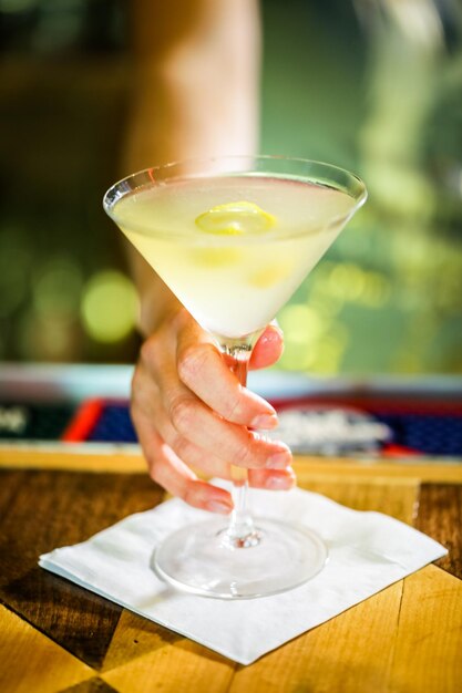 Bartender preparing Limoncello martini coctail.