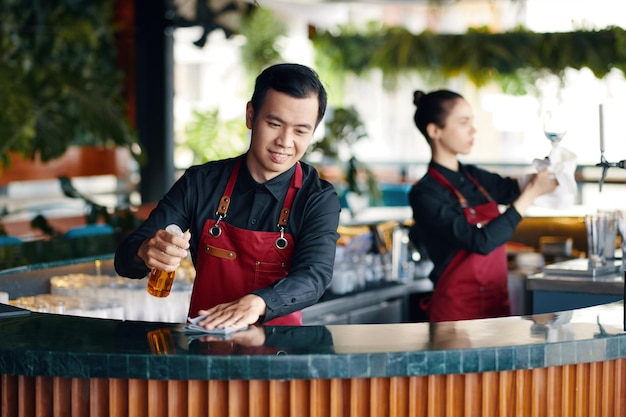 Bartender wiping bar counter