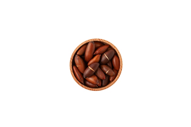 Baru nuts in wooden bowl on white background top view Baru seeds