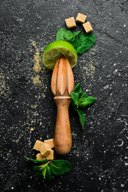 Barware and ingredients for making a Mojito cocktail On a black background Top view