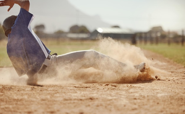 Baseball baseball player running and diving for home plate in dirt during sport ball game competition on sand of baseball pitch Sports man ground slide and summer fitness training at Dallas Texas