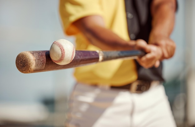 Baseball bat and ball being hit on a field at a sports training practice or competition game Softball sport equipment and man athlete practicing to swing a wood baton on outdoor pitch or stadium