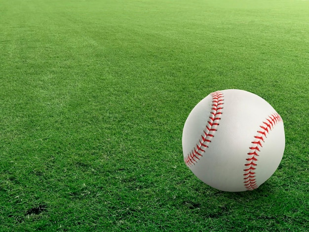 Photo baseball on the clear green grass turf closeup as macro shot with copy space on the left and top