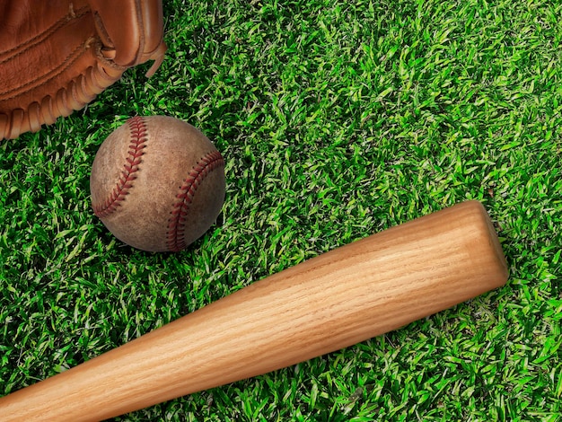 baseball glove ball and bat on field