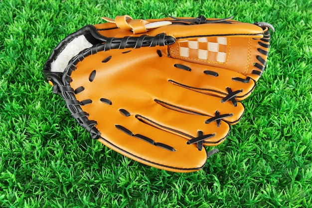 Baseball glove on grass background