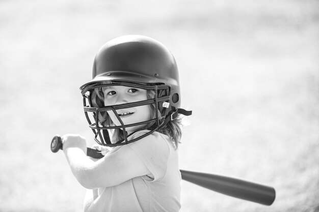 Baseball kid player in baseball helmet and baseball bat