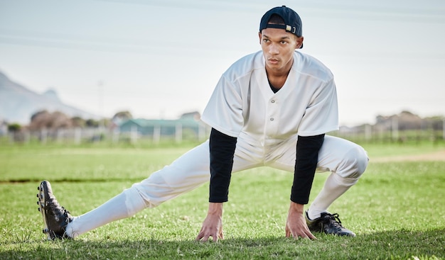 Baseball man and stretching on field fitness and training for match wellness and healthy lifestyle Male athlete player and guy stretch exercise and practice for competition park and balance