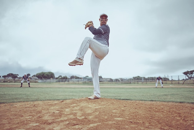 Baseball pitch athlete and man from Guatemala ready to throw for exercise training and game workout Team fitness baseball player and sports with teamwork together on a outdoor dirt field