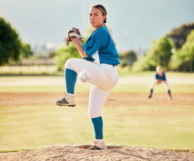 Baseball pitcher ball sports and a athlete woman ready to throw and pitch during a competitive game or match on a court Fitness workout and exercise with a female player training outside on field