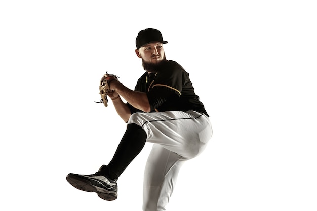 Baseball player in a black uniform practicing and training isolated on a white background