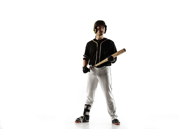 Baseball player in a black uniform practicing and training isolated on a white background