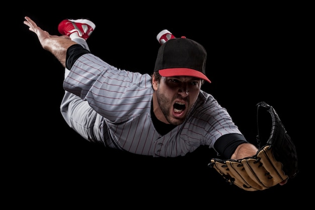 Foto giocatore di baseball che cattura una palla. studio girato.