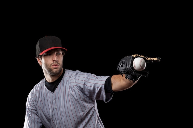 Baseball Player vangen van een bal op een zwarte achtergrond. Studio opname.