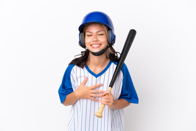 Baseball Russian girl player with helmet and bat isolated on white background smiling a lot