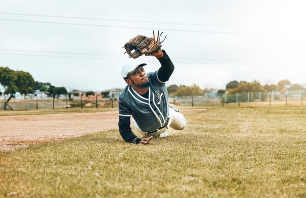 Baseball sports and catch with a man athlete catching a ball during a game or match on a field for sport Fitness exercise and training with a baseball player playing in a competition on grass