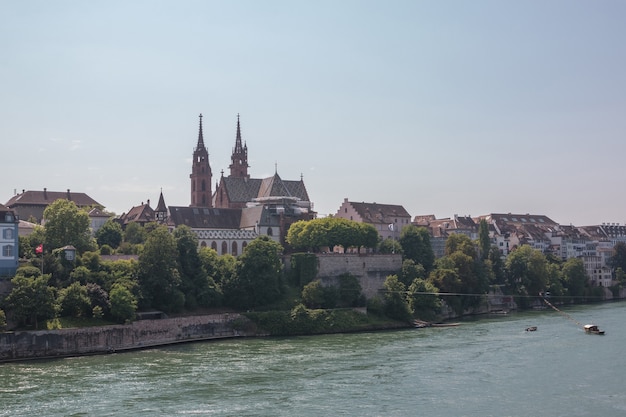 Basel, Switzerland - June 23, 2017: View on Basel city and river Rhine, Switzerland, Europe. People swim in water. Summer landscape, sunshine weather, blue sky and sunny day