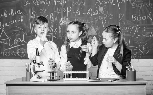 Basic chemical reactions Group school pupils study chemistry in school Boy and girls enjoy chemical experiment Organic chemistry is study of compounds containing carbon Fascinating chemistry