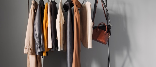 Basic women's autumn wardrobe with shoes and handbags on  hanger