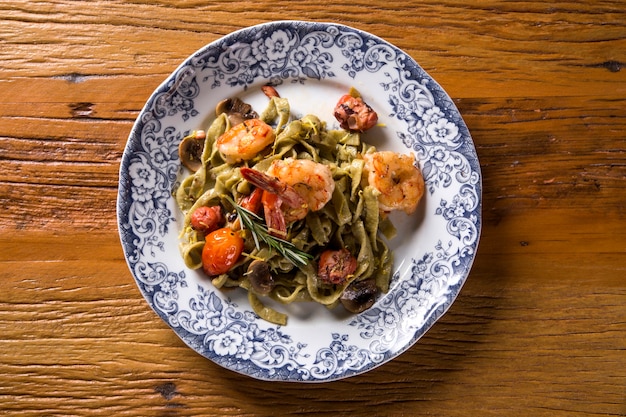 Basil fettuccine with seafood, shrimp and tomato