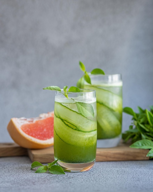 Basil lemonade cocktail with grapefruit on gray background food photo for restaurant menu banners