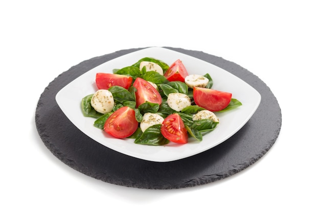 Basil, mozzarella and tomato salad isolated on white