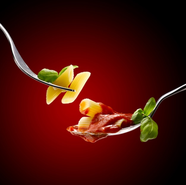 basil pasta and tomato sauce in a fork