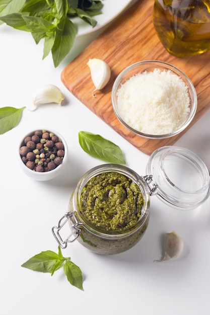 Basil pesto sauce in a jar Ingredients for cooking cheese parmesan garlic olive oil