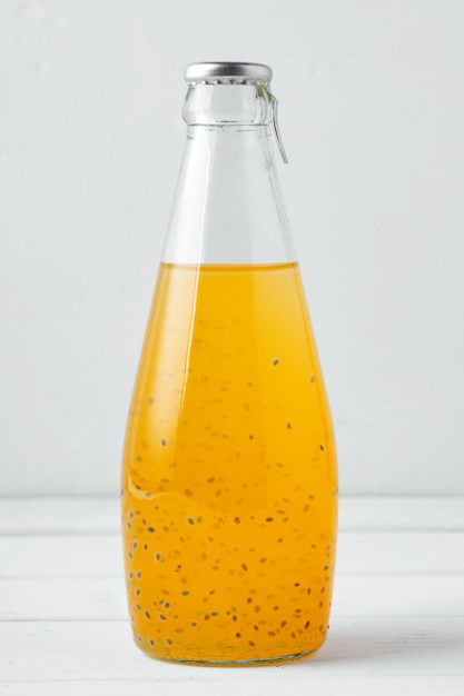 Basil seed drink in glass bottle on white background