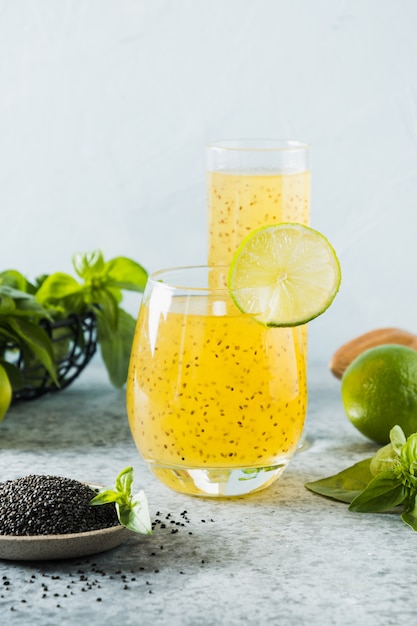 Basil seeds drink with orange slice in glass