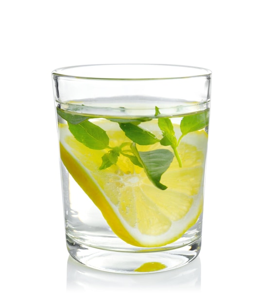 Basil water with lemon in glass isolated on white