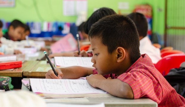 Basisschoolstudent in een Aziatische school. Onderwijs- en leeractiviteiten met klasgenoten