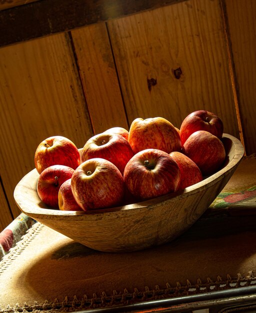 Basket of apples on top of an old wood stove with a window light coming in the background