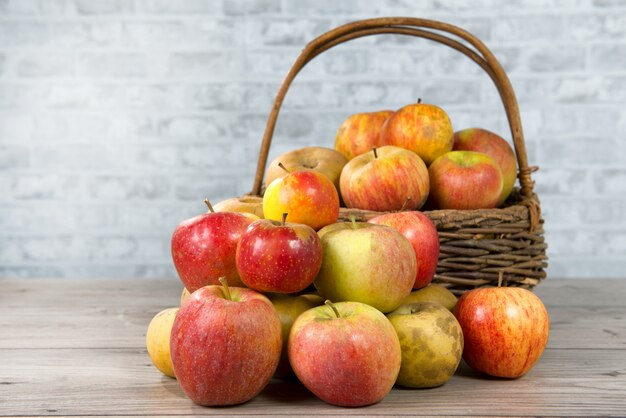 Basket of apples on the wooden table