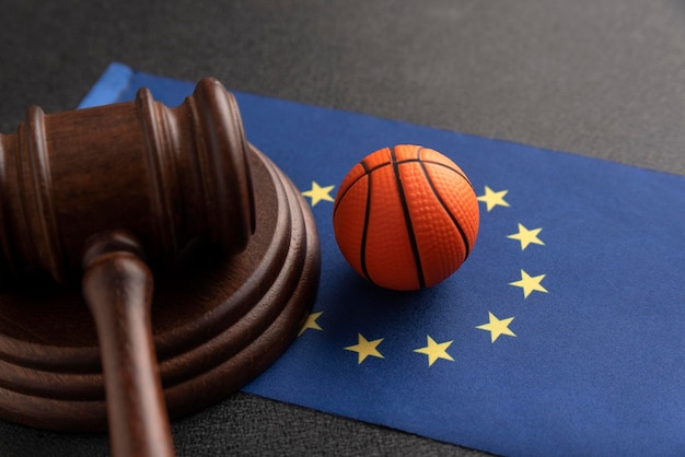 Basket ball and judge gavel on the flag of european union
basketball betting in eu sport betting concept