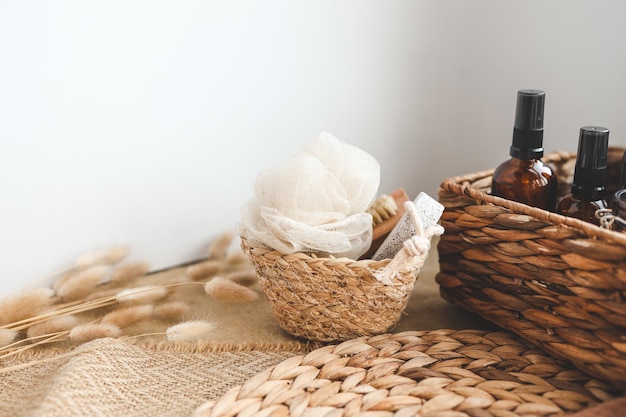 A basket of bath products on a table with a towel on it.