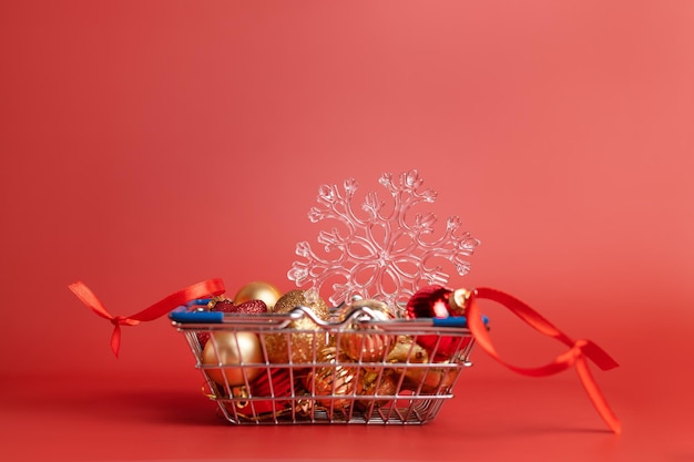 Basket of Christmas toys on a red background  balls stars and snowflake red and gold High qualit